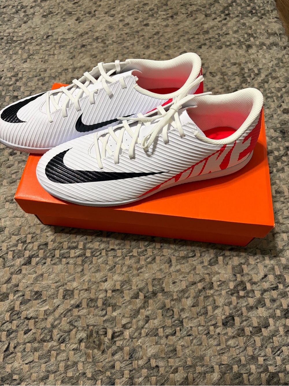Nike White Soccer Cleats with Black Swoosh and Bright Crimson Accents